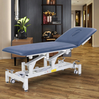 Table de massage électrique réglable en acier inoxydable moderne et luxueuse, design pliable pour salons de beauté commerciaux, cliniques médicales