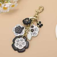 Nouveau porte-clés en cuir fait main à la mode, pendentif camélia avec chaîne pour sac