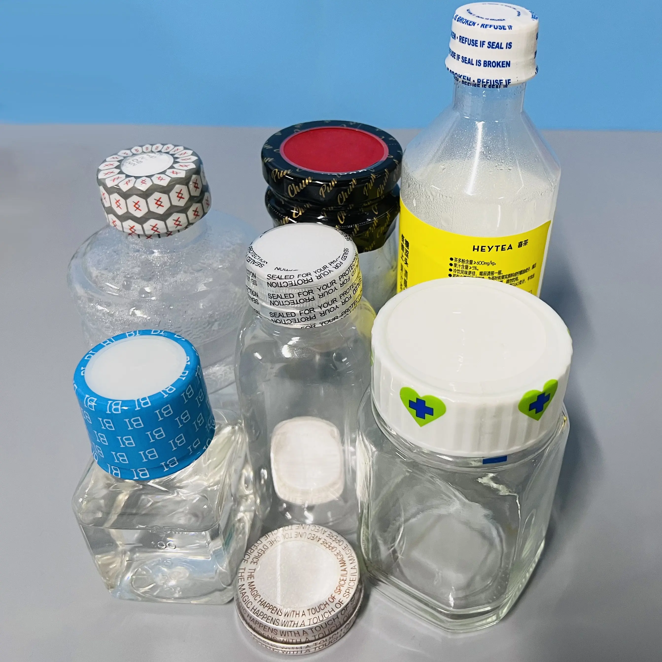 プラスチックボトルキャップを包装するためのカスタムPVC穴あき熱収縮シールフィルムラップバンドガラス瓶ネック