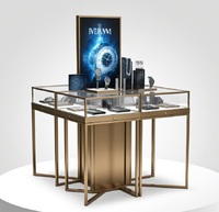 Comptoir de présentation de bijoux et montres multi-compartiments sur mesure, vitrine îlot en verre doré brossé avec tiroirs de rangement et éclairage LED