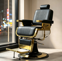Fauteuil de barbier de luxe rétro avec cadre en métal plaqué or noir, coutures verticales, inclinable hydrauliquement