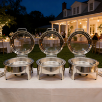 Plateau de buffet isotherme rond en acier inoxydable argenté avec couvercle en verre, idéal pour les services de restauration hôtelière et les événements.