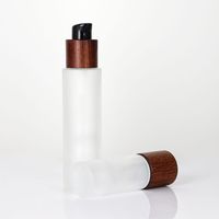 Ventas calientes Ash Tree Tapa de aerosol de madera Tapa de bambú Botellas de bomba de vidrio cosmético para cosméticos