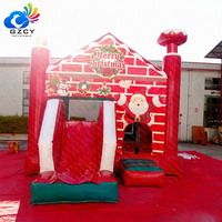 Château gonflable de Noël avec mur de briques et toboggan pour enfants, idéal pour les événements et fêtes de fin d'année à louer