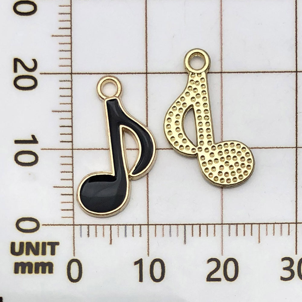 Una nota musical negra, rociada con aceite - 0.6g - 19*12mm - 19447