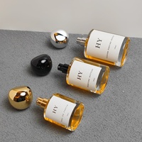 Flacon vaporisateur de parfum en verre cylindrique minimaliste 30ml 50ml 100ml personnalisable avec bouchon en forme de pierre