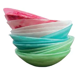 Handcrafted food safe resin bowl with marble pattern and aqua swirl pattern used to contain salad jam and ice cream