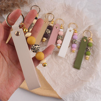 Porte-clés en cuir PU avec breloque de sac en silicone perlé imprimé léopard, pendentif de clé de voiture fait main, accessoire de mode féminin pour cadeau