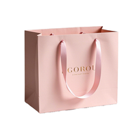 Sac en papier recyclable de luxe SHINY 300GSM en carton ivoire robuste, avec ruban laminé premium, poignées découpées et gaufrées haut de gamme