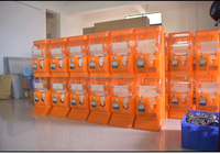 Distributeur automatique de capsules mécaniques miniatures orange, fonctionnant à pièces, avec construction en métal et plastique, garantie 1 an pour usage commercial