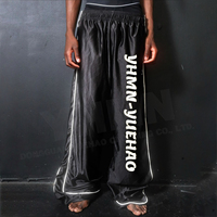 Pantalon de jogging ample et réfléchissant noir imperméable coupe large coupe oversize style streetwear pour homme