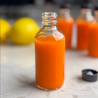 En stock Bouteilles de jus rondes en verre transparent Boston 60ml 120ml 250ml Petits shots bien-être de 2oz Coups de jus de gingembre avec couvercle hermétique