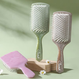 Brosse à cheveux démêlante ronde à manche en plastique, style creux, pour usage domestique, vente en gros à bas prix - Product Image 1