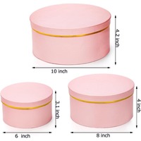 Boîte cadeau ronde avec couvercle, présentant un motif floral rose avec bordure dorée, personnalisable selon vos besoins