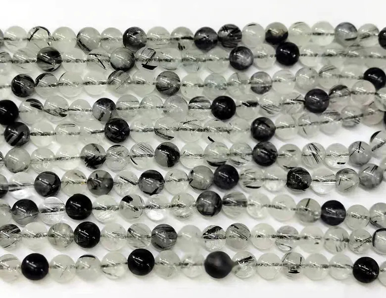 Branelli allentati della pietra del quarzo rutilato nero della pietra preziosa liscia naturale all'ingrosso di fascino per la fabbricazione dei gioielli
