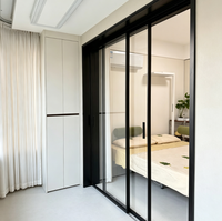 Porte patio coulissante à deux panneaux, cadre noir mat, verre transparent, poignée encastrée, jardin zen, aluminium