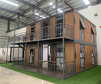Maison conteneur extensible de 20 pieds à double aile, préfabriquée, résistante aux ouragans, unité de logement modulaire fixée par câbles en acier