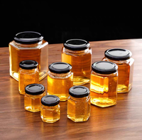 Toples penyimpanan kaca transparan, toples madu segi enam dengan tutup sekrup digunakan untuk madu dan gula botol kaca bening