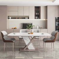 Ensemble de table à manger en pierre frittée facile à nettoyer avec base noire en forme de X et 4 chaises de couleurs mélangées, conçu pour les repas en famille