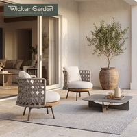 Fauteuil de salon sculptural tressé avec dossier en corde croisée, base de siège ronde et coussins pour projets de villas de luxe et terrasses - Vente en gros