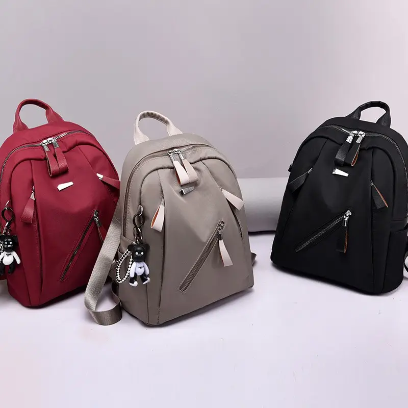 Mochila con colgante de osito para mujer, mochila escolar de gran capacidad para niñas, mochila de Color puro para mujer JY220826, resistente al agua, OEM diario