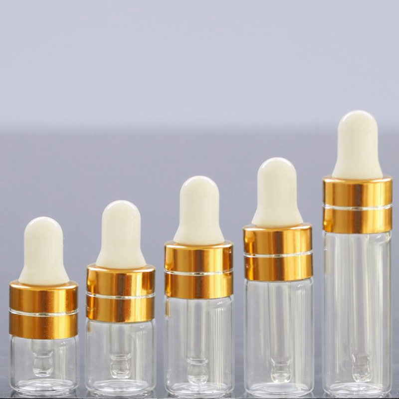 Tapa cuentagotas transparente + dorada con línea plateada + tetina blanca