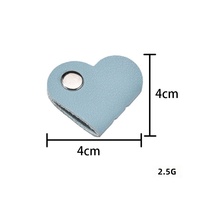 Organisateur de câbles mignon en forme de mini-cœur, support portable en cuir PU pour écouteurs, accessoire de fixation de câbles en gros pour usage quotidien