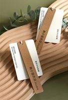 Étiquette suspendue de luxe personnalisée en papier texturé brillant gaufré, couleur au choix, respectueuse de l'environnement, pour vêtements