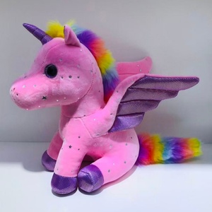 Unicornio de peluche sentado con estampado de estrellas azul cielo y crin y cola arcoíris esponjosos - Product Image 4