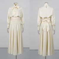 Ensemble deux pièces chic abricot pour femme, haut à col montant et manches bouffantes avec nœud, jupe fluide froncée taille haute, style minimaliste et élégant pour soirée, vente en gros