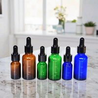 Bouteille en verre de parfum d'huile essentielle avec compte-gouttes de pipette graduée pour l'emballage cosmétique rond de crème pour le visage et de gouttes oculaires