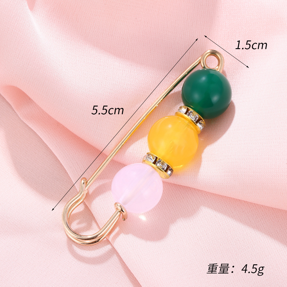 Trois perles en vert, jaune et rose (5,5*1,5 cm)