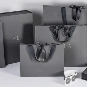 Logo personalizzato stampato sac en papier di lusso nero opaco Shopping sacchetti regalo di carta confezione con manico a nastro
