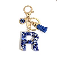 Porte-clés en résine Lettre Œil Turc avec breloque alphabet incrustée de feuille d'or, pompon et accessoires dorés, accessoire de mode pour sac