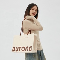 Sac cadeau en papier couché de luxe écologique de haute qualité, design découpé à la main, logo personnalisé, lamination numérique, papier épais sans couture