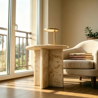 Table basse en marbre travertin beige à pieds croisés, style moderne et organique, idéale pour l'aménagement intérieur Japandi et les cafés chaleureux