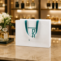 Sac en papier de luxe pour parfum, emballage cadeau pour bijoux, sac de shopping personnalisé avec logo de marque imprimé, poignée en corde et ruban pour boutique