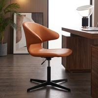 Chaise de négociation élégante en cuir camel orange avec dossier à ailes et base quatre branches noire pour bureau créatif