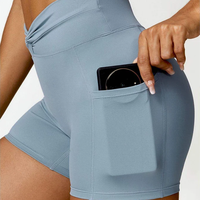 Shorts de sport pour femmes OEM avec logo personnalisé, taille haute torsadée, poches latérales pour téléphone, effet ventre plat et rehaussement des fesses, pour yoga, course à pied et cyclisme