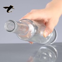 Bouteilles de vin rondes en verre transparent, vente en gros à prix d'usine pour whisky, tequila, brandy, boissons énergisantes avec bouchon en liège