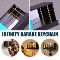 Porte-clés de garage multifonctionnel de luxe noir en ABS avec crochet infini et lumière LED, fixation murale adhésive pour clés de voiture