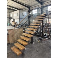 Escalier minimaliste en acier à poutre unique avec marches en verre flottantes personnalisées et poutre centrale pour la maison