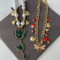 Collier multi-pendentifs papillon vert tendance 2025 avec perles et chaînes superposables