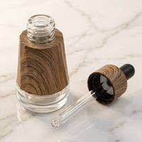 Flacon compte-gouttes OEM personnalisé 30 ml en verre de luxe à grain de bois, avec manchon en bois de café et bulbe en caoutchouc pour bouteilles d'huiles essentielles