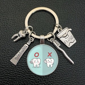 Porte-clés en métal avec pendentif en forme de fil dentaire, dentifrice, <span class=keywords><strong>brosse</strong></span> <span class=keywords><strong>à</strong></span> dents, cabochon en verre, cadeau <span class=keywords><strong>pour</strong></span> dentiste, assistant dentaire, soins <span class=keywords><strong>dentaires</strong></span> - Product Image 6