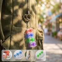 Porte-clés lumineux anti-stress avec lumières LED colorées, jouet pour enfants et adultes, en plastique.