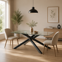 Table à manger moderne minimaliste de luxe avec plateau en verre trempé transparent, base en acier noir enduit de poudre, pieds en métal en forme de X