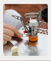 Réchaud miniature portable monobloc en acier inoxydable de qualité supérieure, ultra-léger, simple, pour l'extérieur, avec déflecteur de vent et allumage intégré