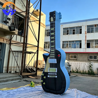 Guitare gonflable publicitaire personnalisée en tissu Oxford avec ventilateur intégré pour la décoration de scène de festival de musique