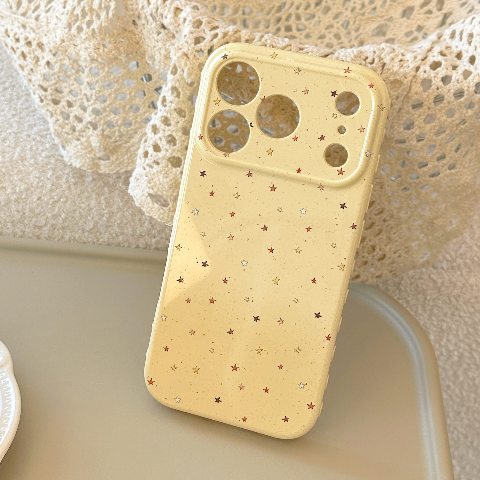 Lemon yellow, flecked red-brown star